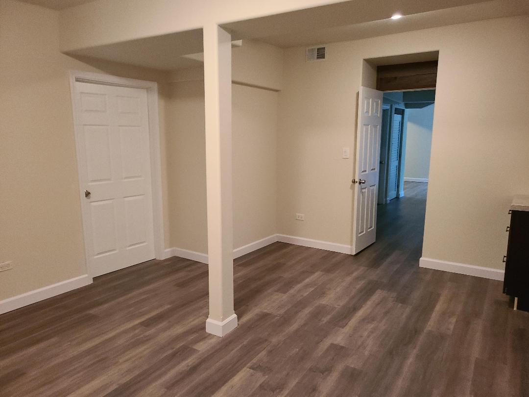 2103 Main Street, Unit L Spring Grove, IL 60081 - Photo 9 of 9 a view of a hallway with wooden floor