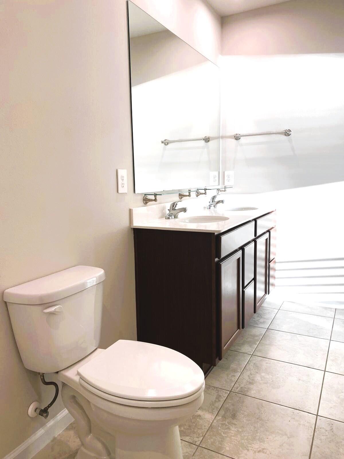 106 Pummelo Place Fort Pierce, FL 34981 - Photo 15 of 27 a bathroom with a sink toilet and mirror