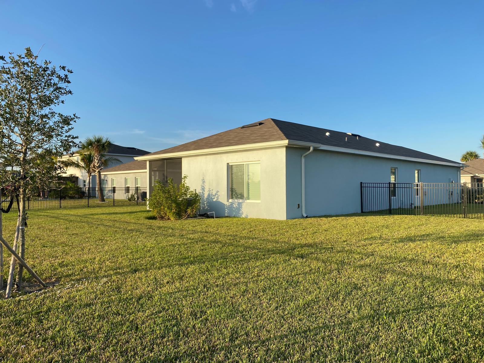 106 Pummelo Place Fort Pierce, FL 34981 - Photo 22 of 27 a front view of a house with garden