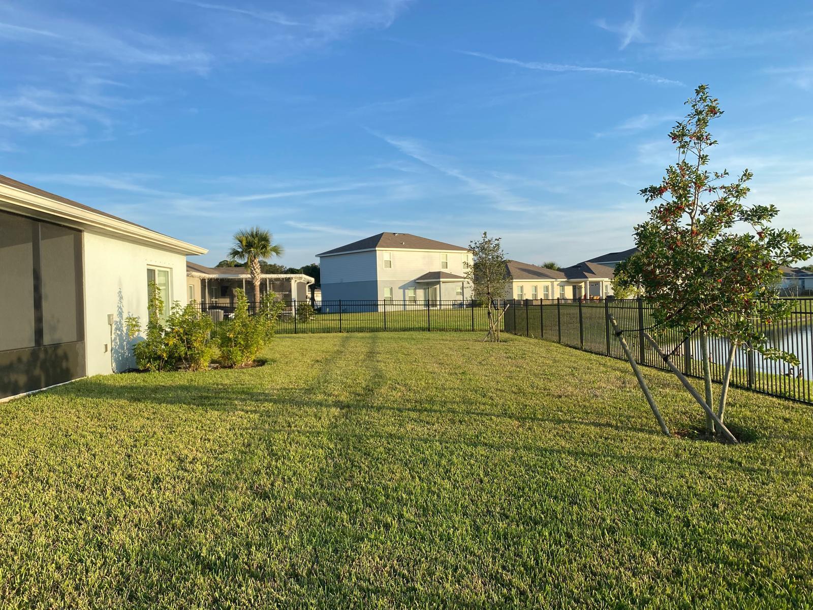 106 Pummelo Place Fort Pierce, FL 34981 - Photo 24 of 27 a view of a yard with a house