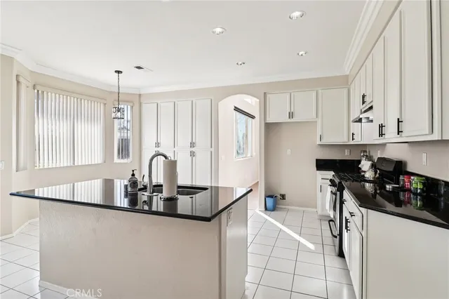 a kitchen with stainless steel appliances kitchen island granite countertop a sink and cabinets