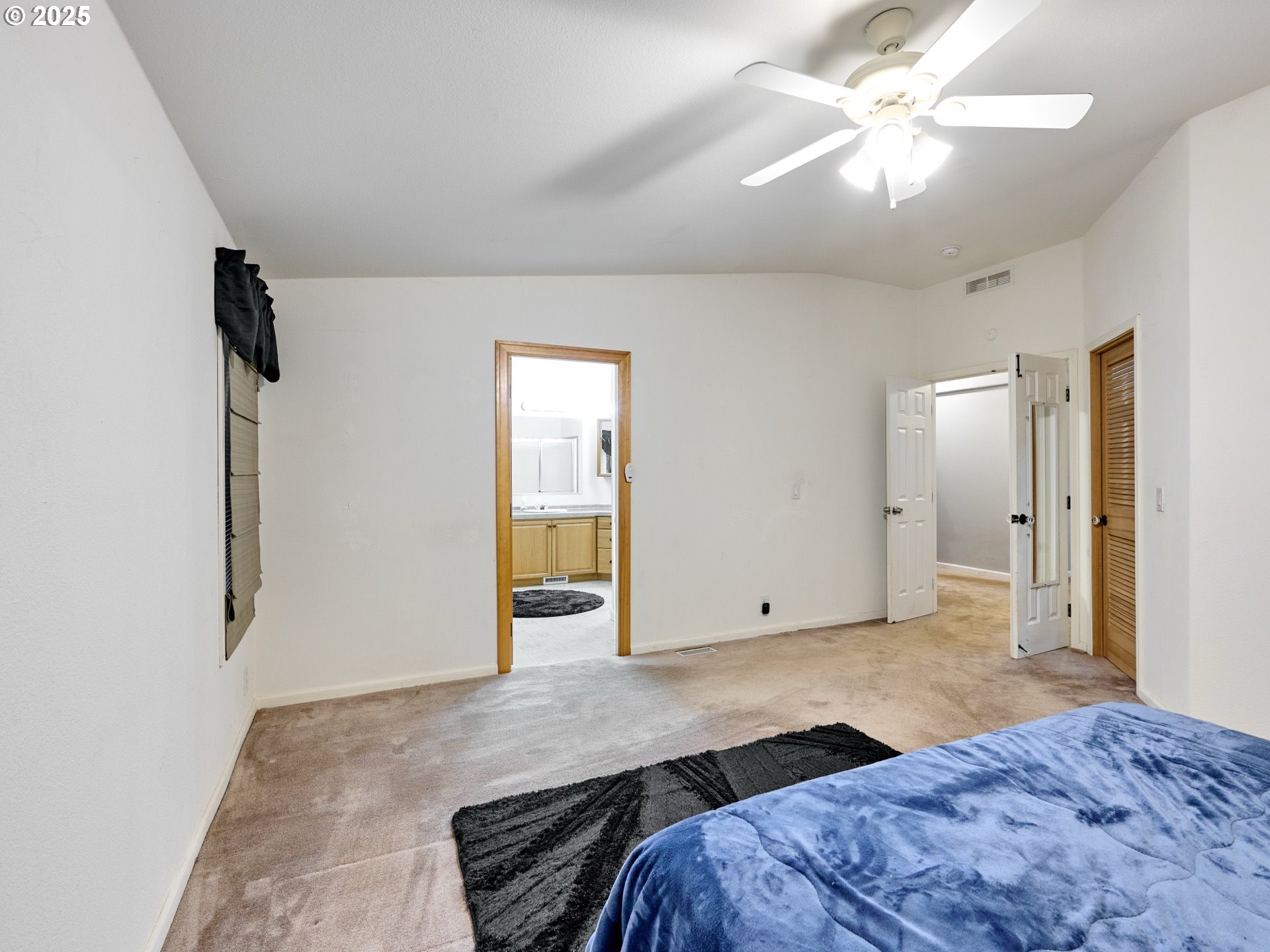 20788 Hazelnut Ridge Road Scotts Mills, OR 97375 - Photo 20 of 46 a bedroom with a large bed and a chandelier