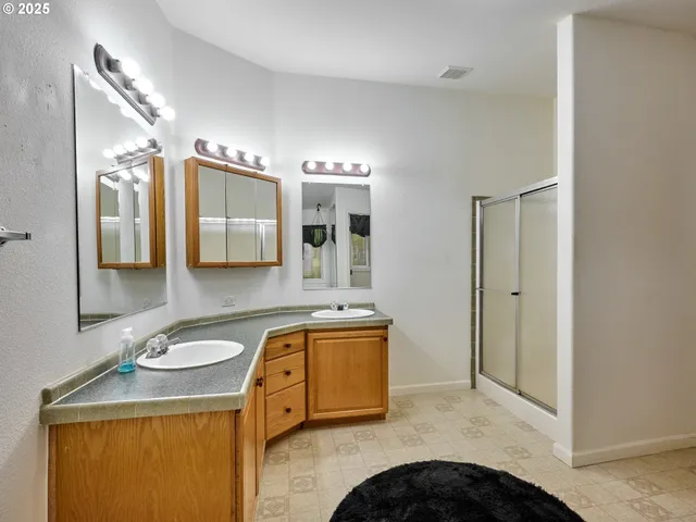a bathroom with a sink vanity and mirror
