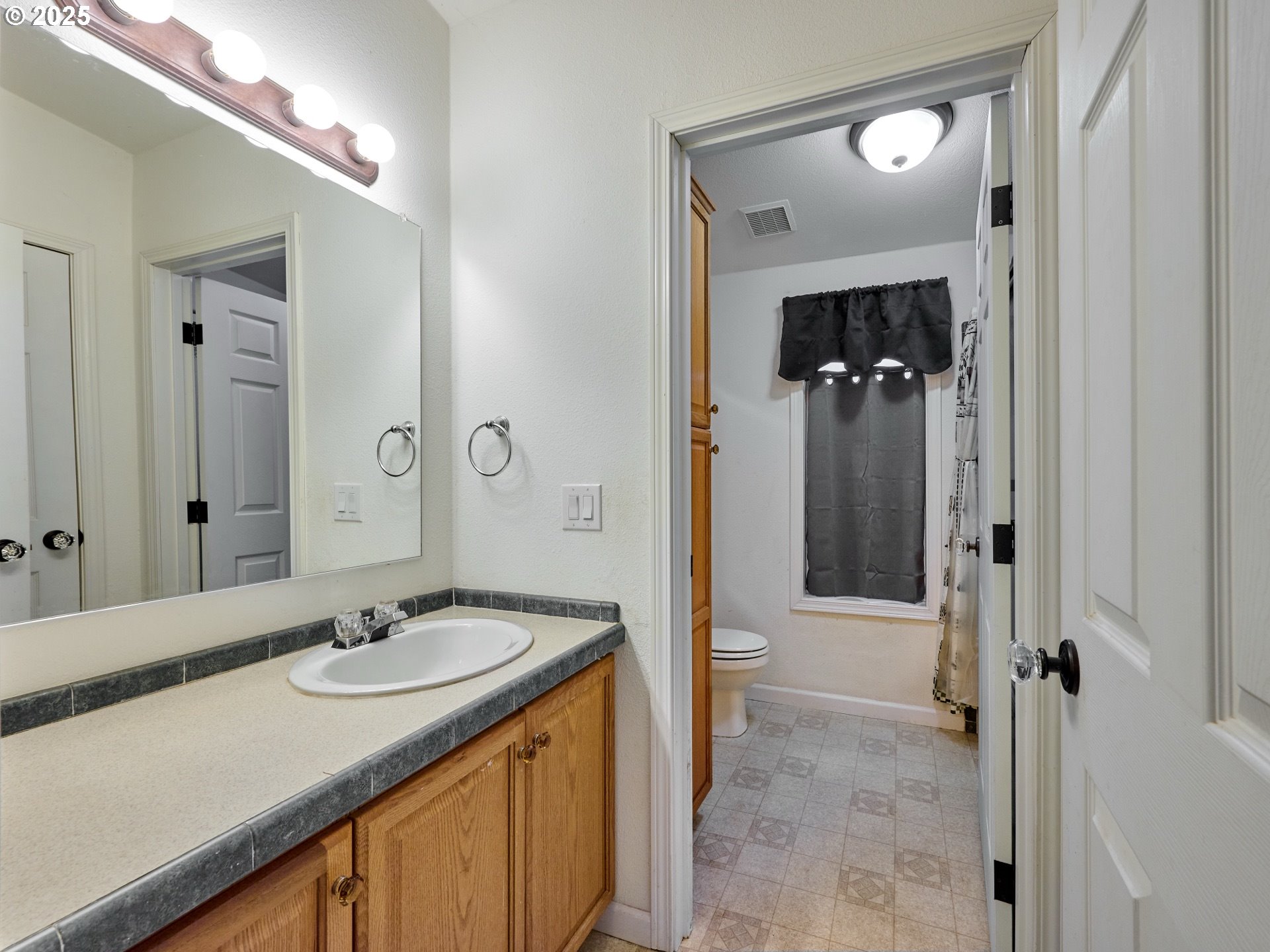 20788 Hazelnut Ridge Road Scotts Mills, OR 97375 - Photo 26 of 46 a bathroom with a sink vanity granite shower and a mirror