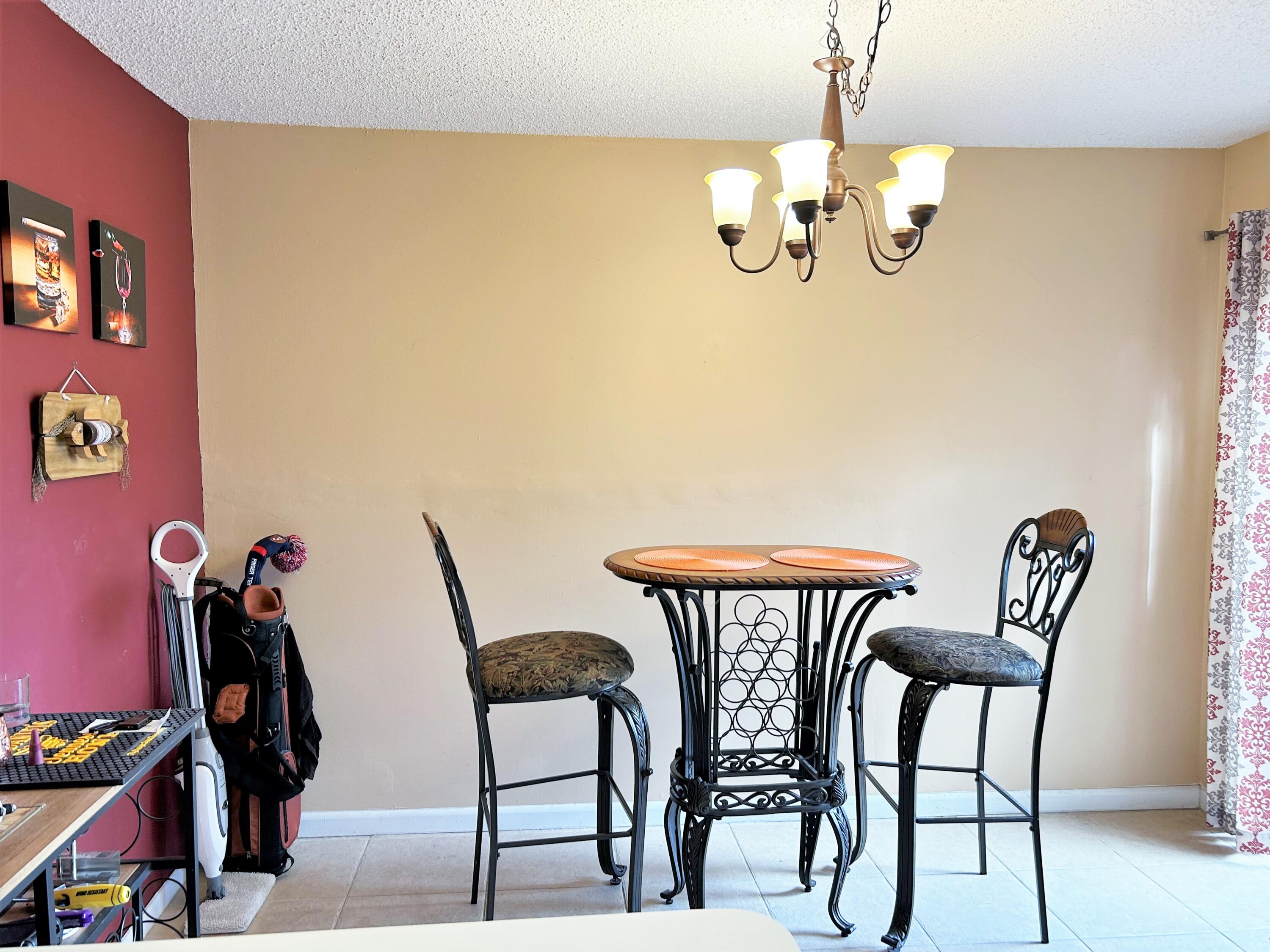 201 Meadows Drive Boynton Beach, FL 33436 - Photo 11 of 40 a view of a dining room with furniture and chandelier