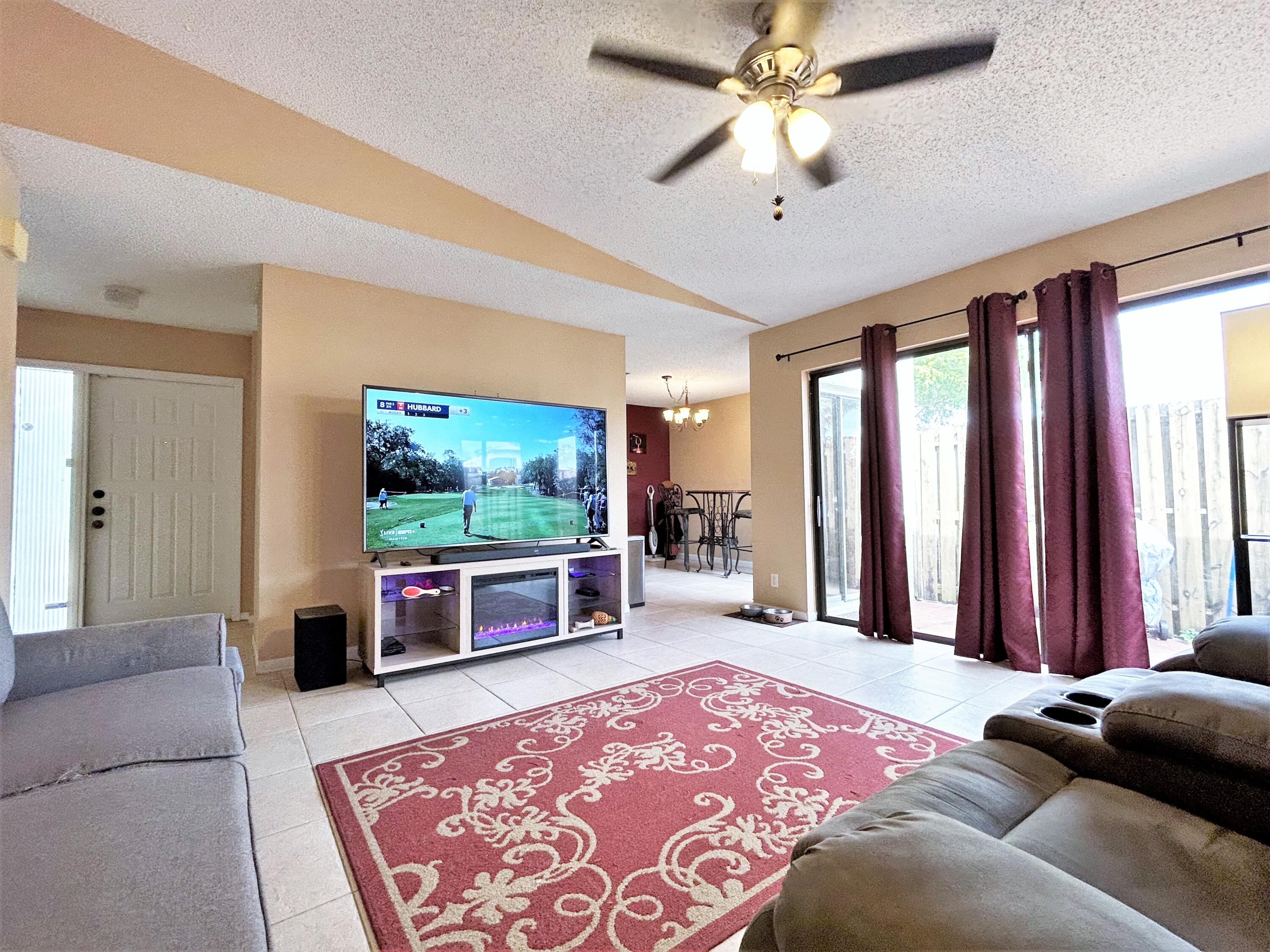 201 Meadows Drive Boynton Beach, FL 33436 - Photo 14 of 40 a living room with furniture and a flat screen tv