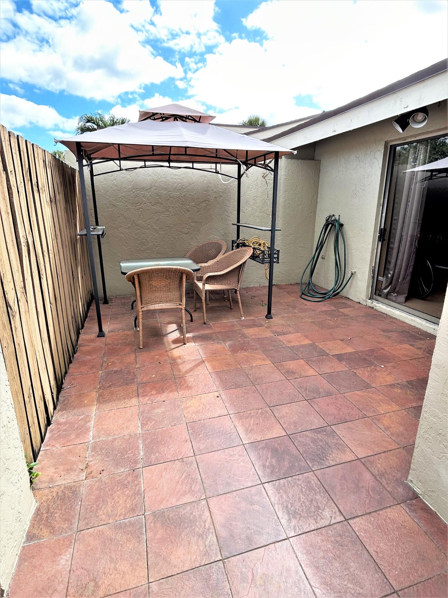 201 Meadows Drive Boynton Beach, FL 33436 - Photo 17 of 40 a view of a terrace with furniture and floor to ceiling window