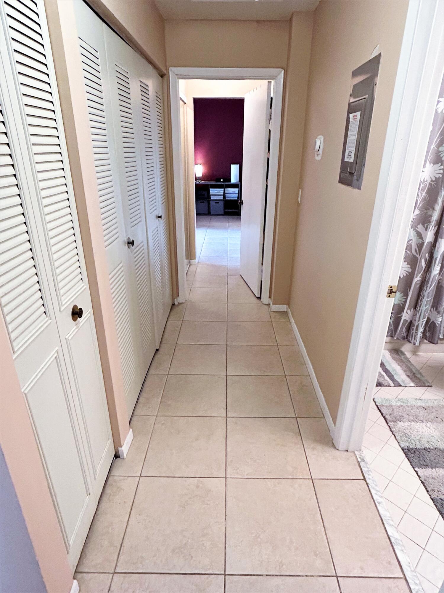 201 Meadows Drive Boynton Beach, FL 33436 - Photo 25 of 40 a view of a hallway view with wooden floor and staircase