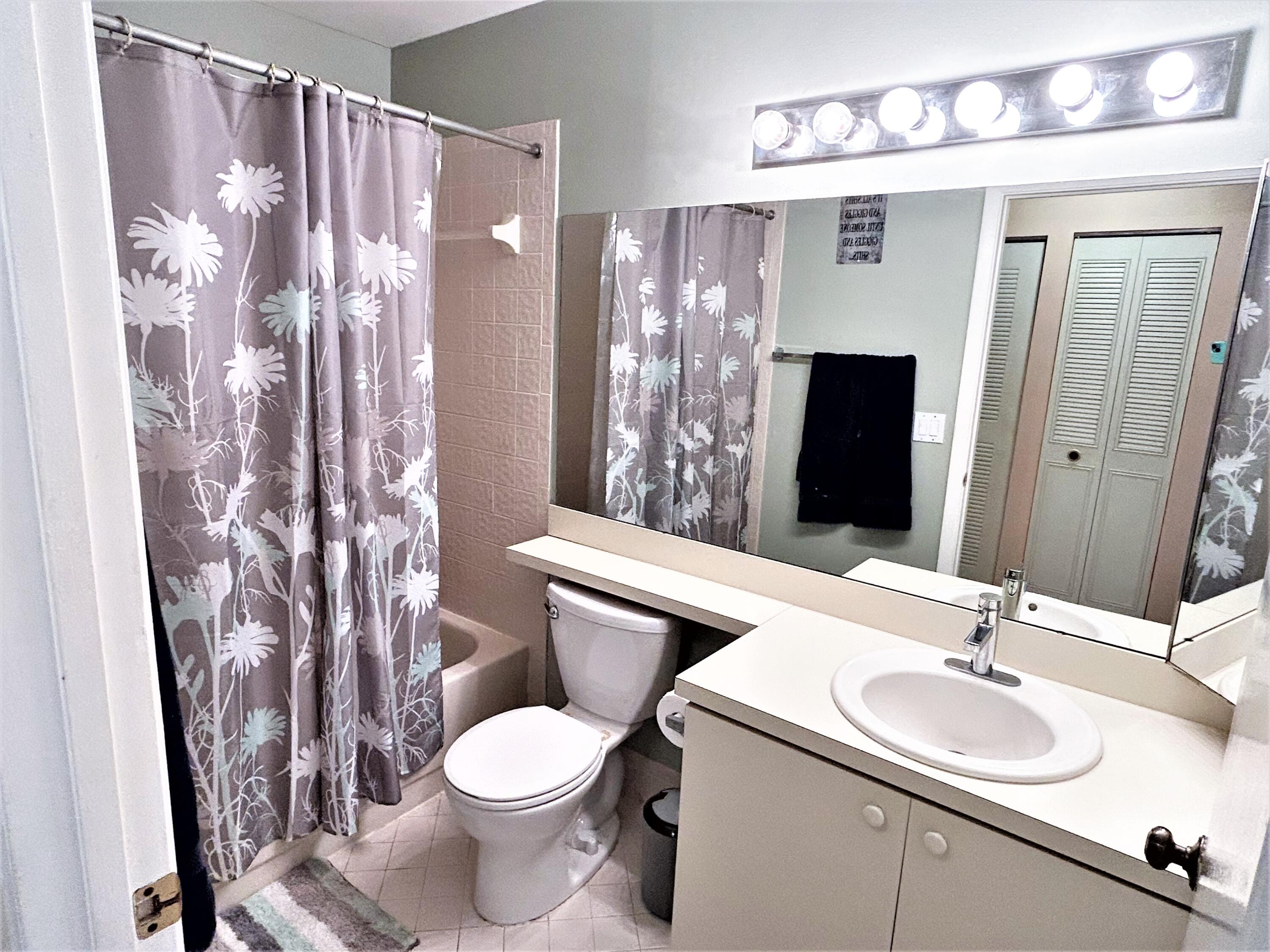 201 Meadows Drive Boynton Beach, FL 33436 - Photo 27 of 40 a bathroom with a sink toilet and shower