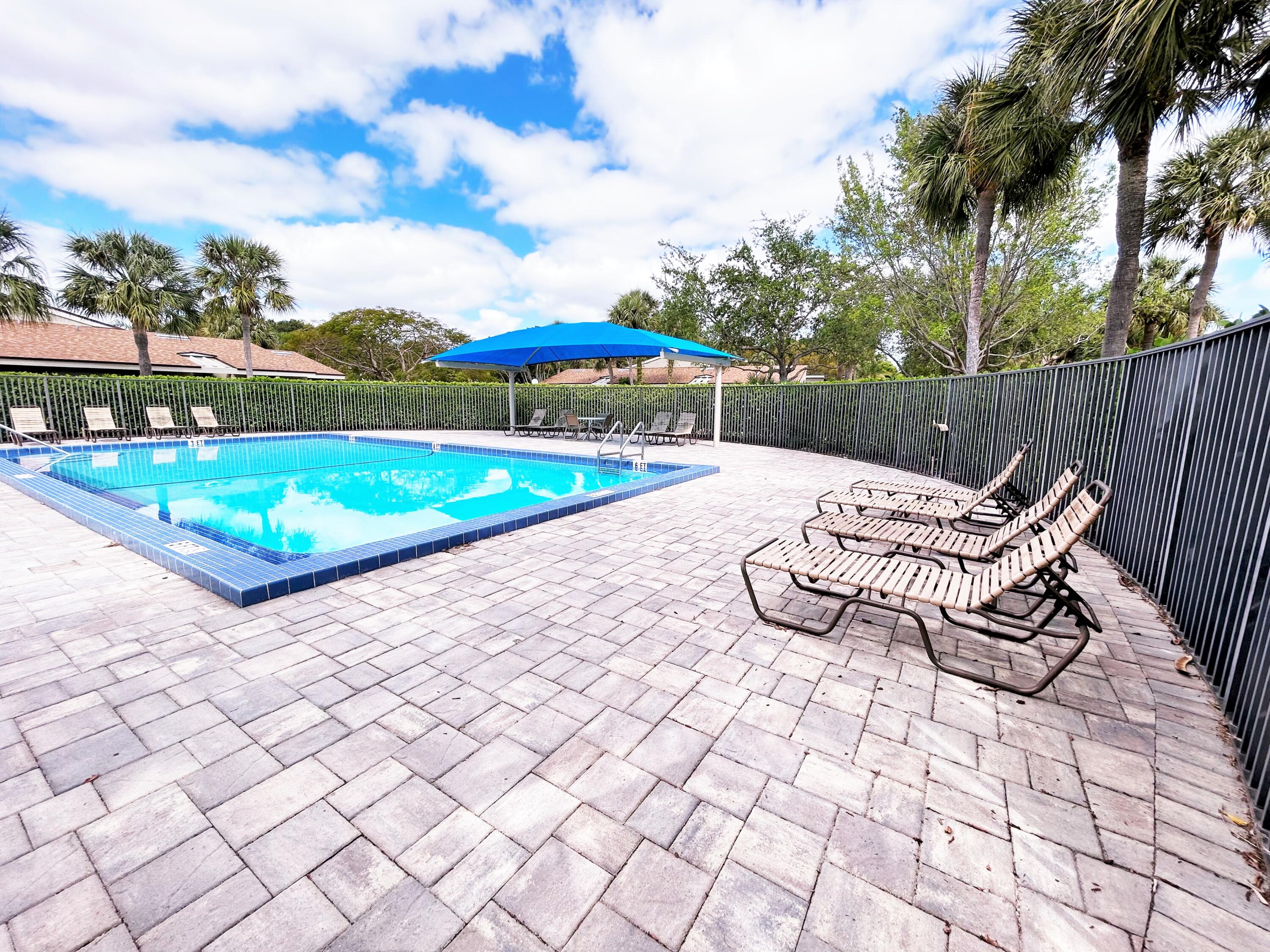 201 Meadows Drive Boynton Beach, FL 33436 - Photo 32 of 40 a view of a swimming pool with a yard and furniture