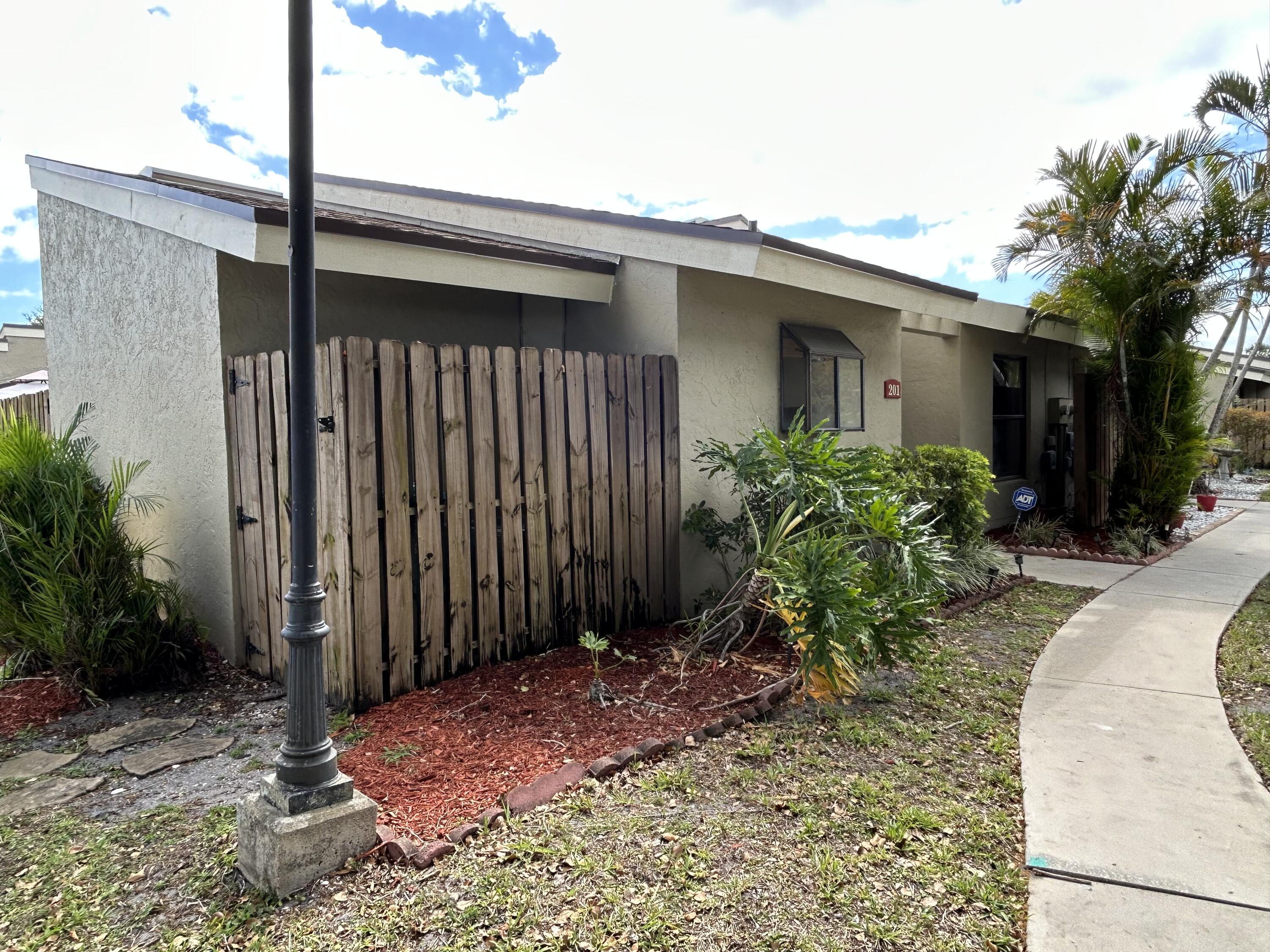 201 Meadows Drive Boynton Beach, FL 33436 - Photo 33 of 40 a couple of potted plants in front of door