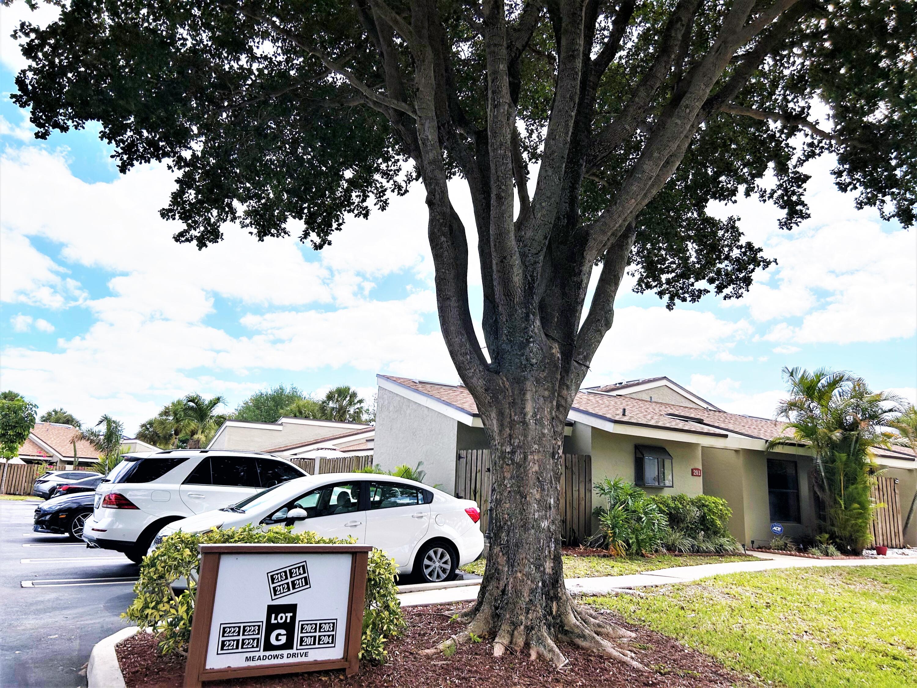 201 Meadows Drive Boynton Beach, FL 33436 - Photo 35 of 40 a car parked in front of white house
