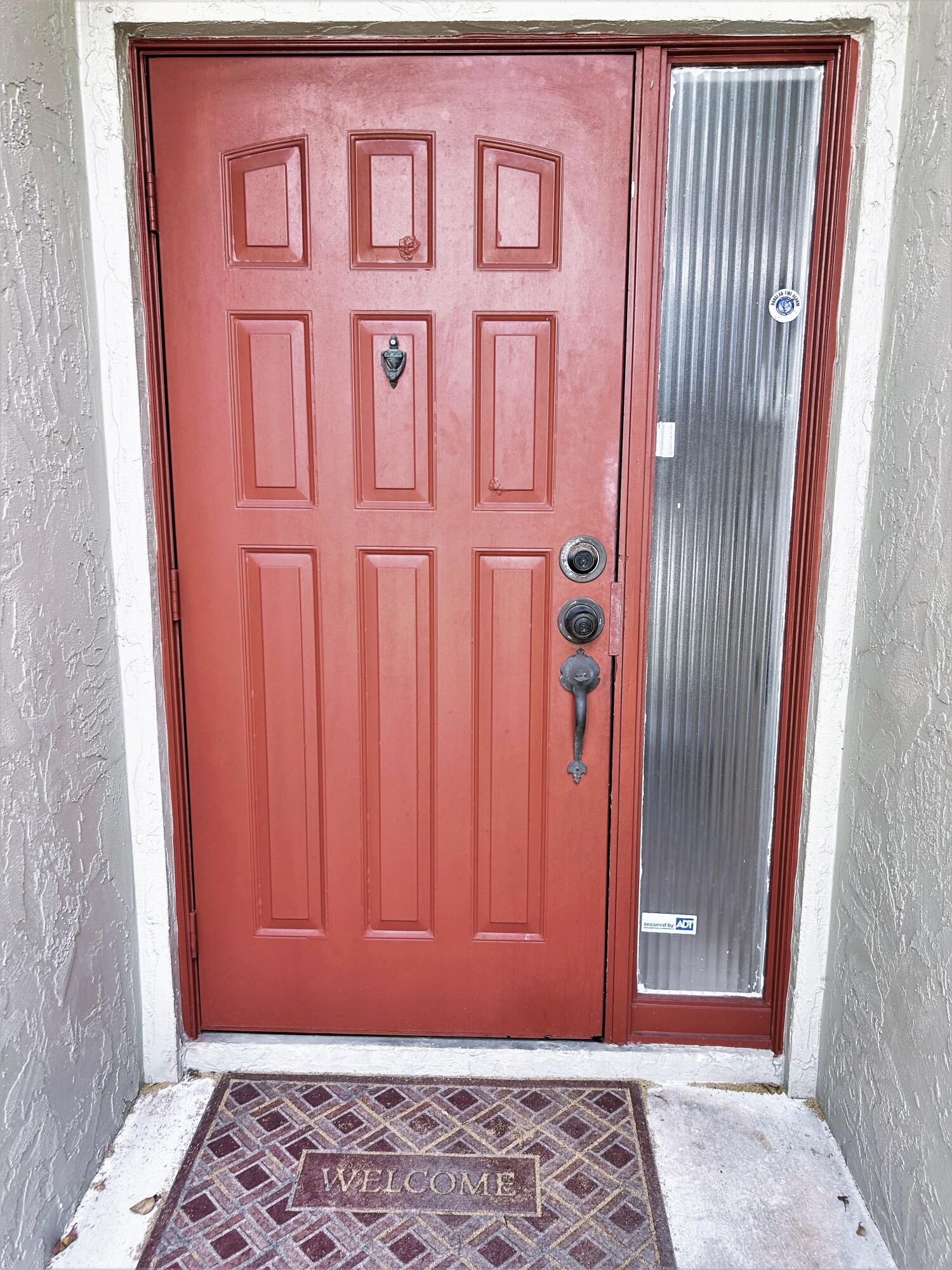 201 Meadows Drive Boynton Beach, FL 33436 - Photo 4 of 40 a view of a door with a red door
