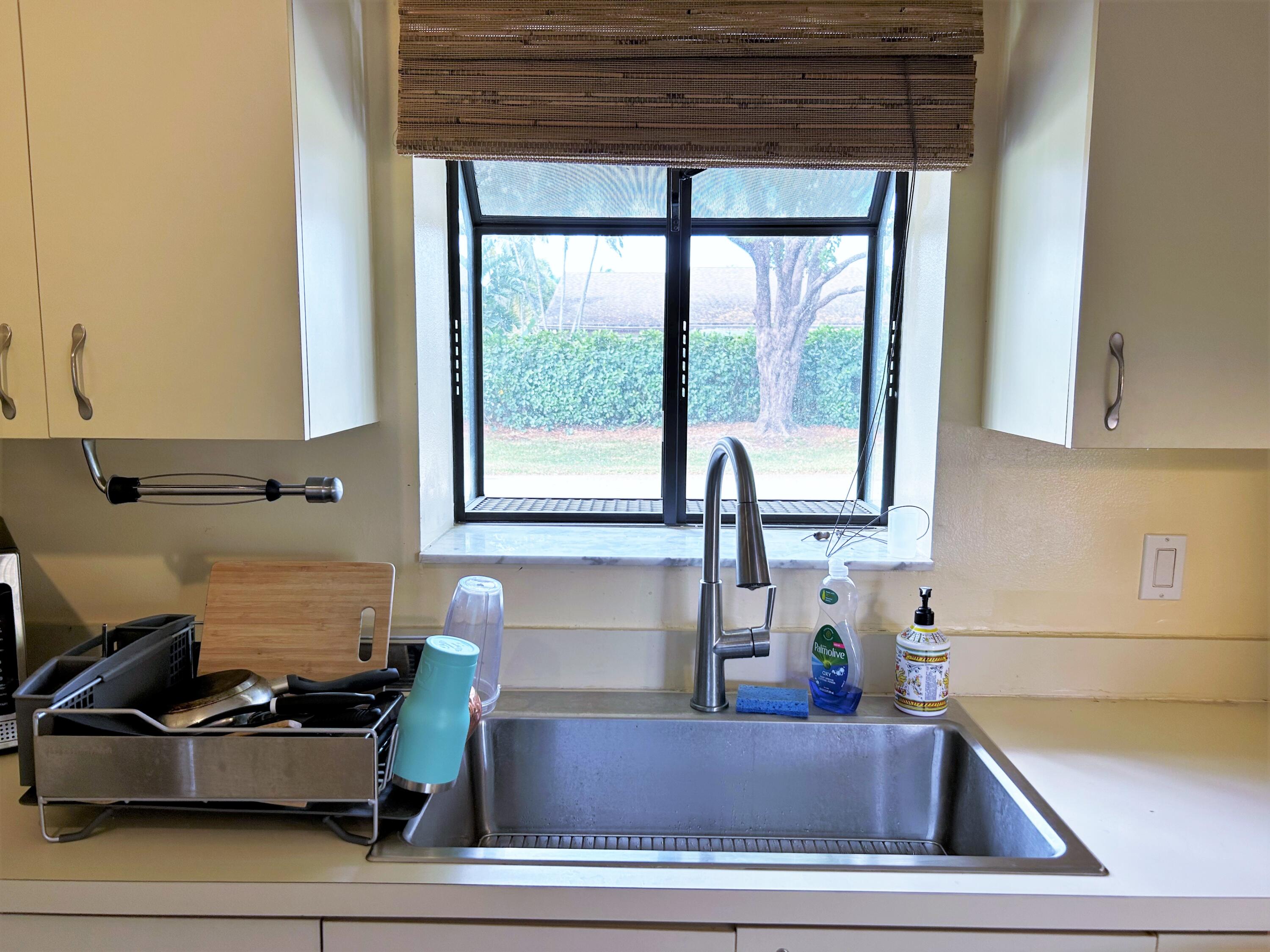 201 Meadows Drive Boynton Beach, FL 33436 - Photo 7 of 40 a kitchen with a sink and a window