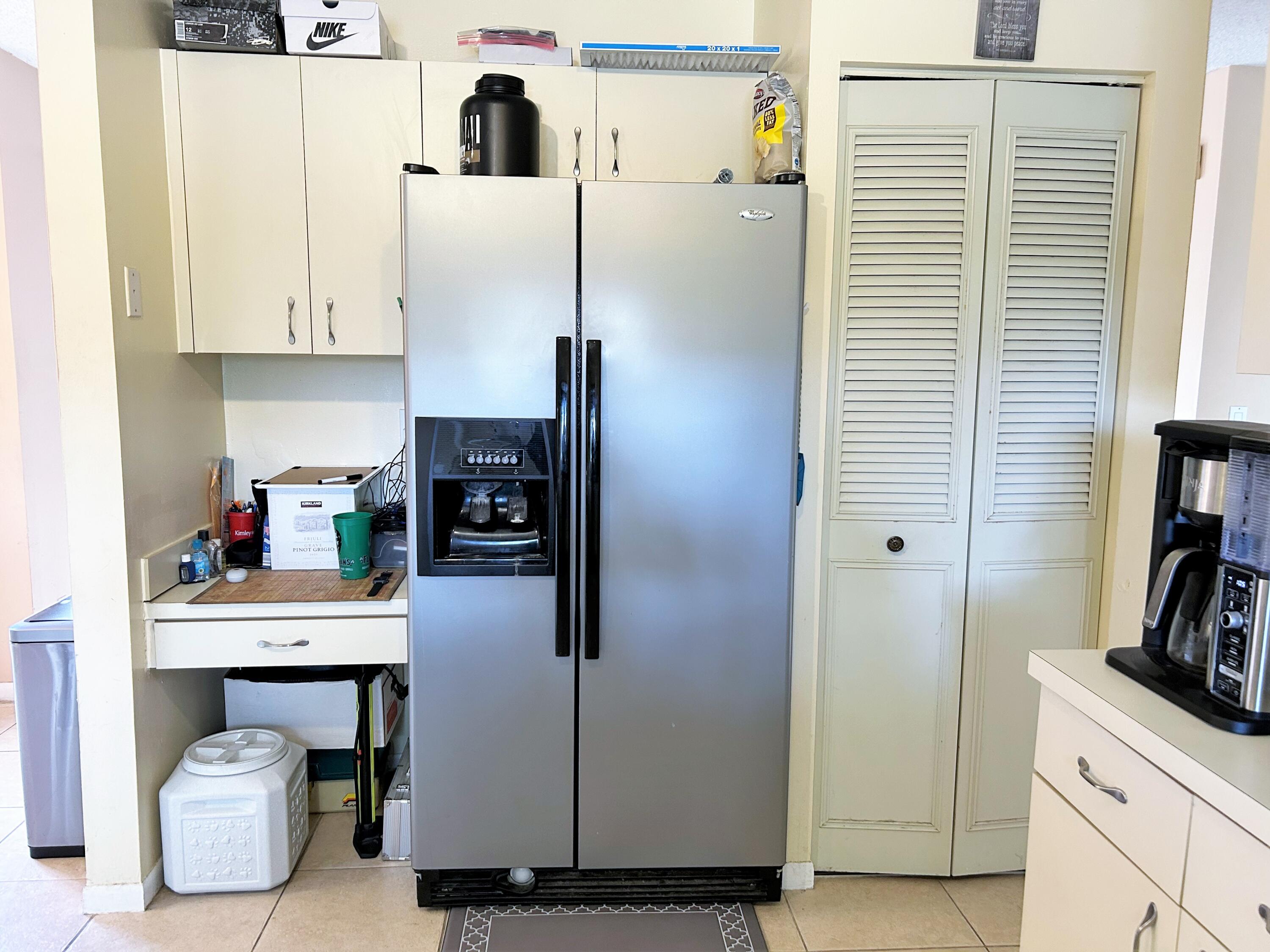 201 Meadows Drive Boynton Beach, FL 33436 - Photo 8 of 40 a kitchen with stainless steel appliances a refrigerator and cabinets