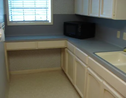 a kitchen with a cabinets and a microwave
