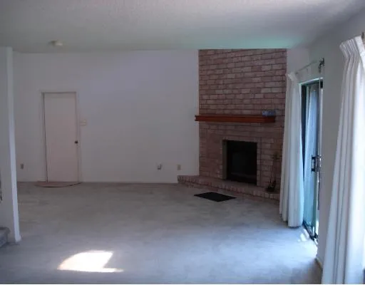 a view of empty room with a fireplace
