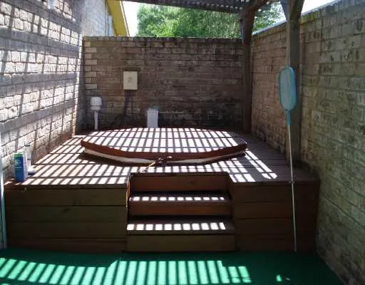 a backyard of a house with table and chairs