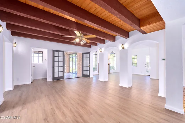 a view of a room with wooden floor and chandelier
