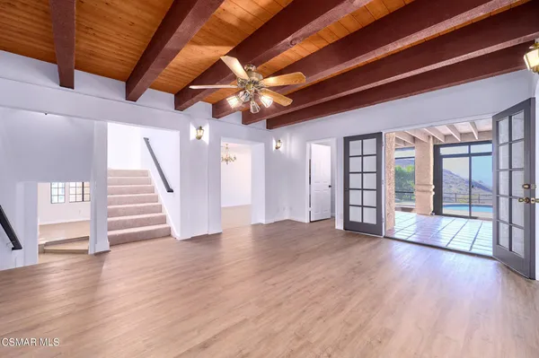 a kitchen with stainless steel appliances granite countertop a stove a sink dishwasher and a refrigerator with wooden floor