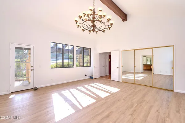 a view of a livingroom with a chandelier fan and a window