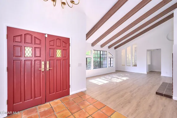 a view of an empty room with a fireplace and a window