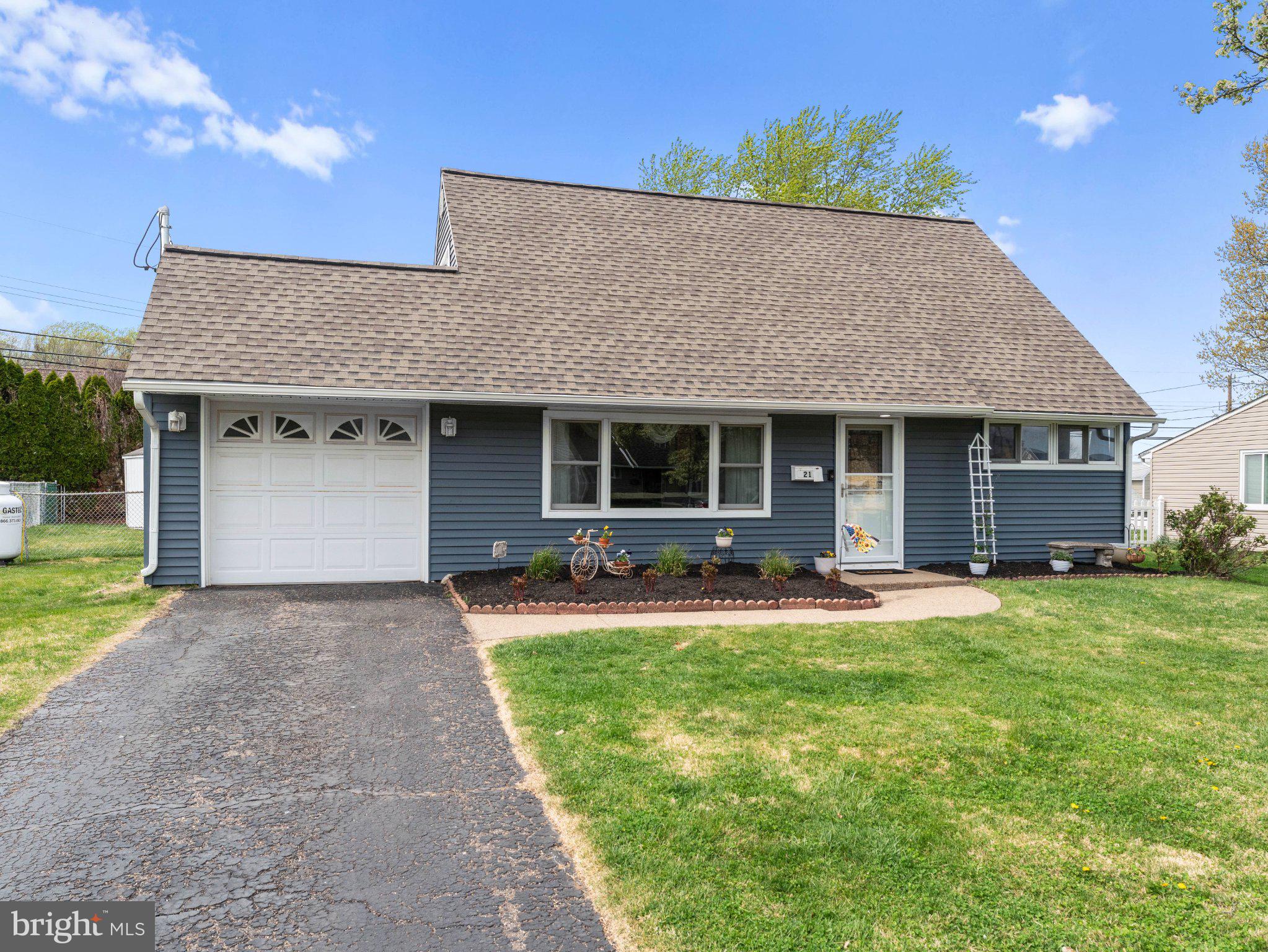 21 Viewpoint Lane Levittown, PA 19054 - Photo 2 of 26 a front view of a house with a yard and garage