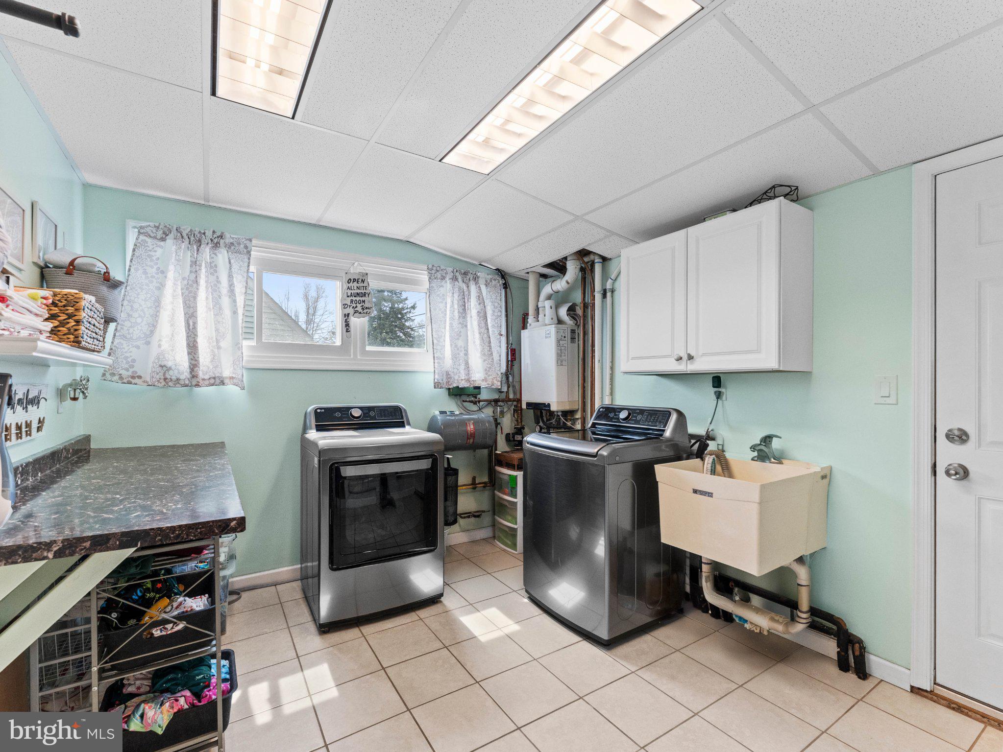 21 Viewpoint Lane Levittown, PA 19054 - Photo 22 of 26 a kitchen with a stove a sink and a microwave