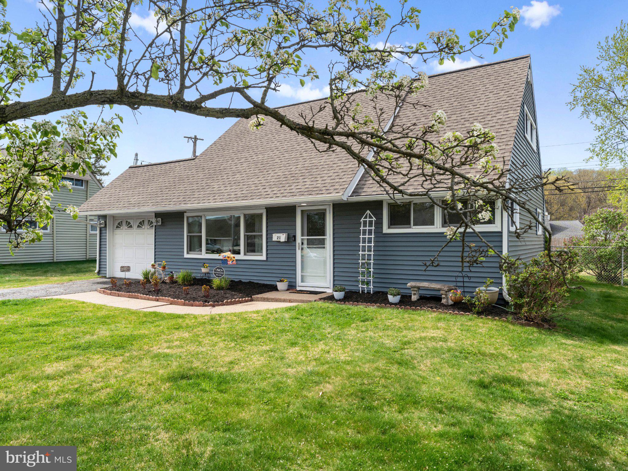 21 Viewpoint Lane Levittown, PA 19054 - Photo 3 of 26 a front view of a house with a yard and garage