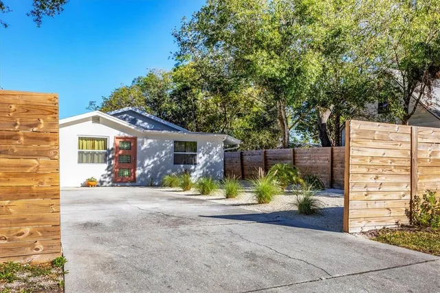 a bedroom with a large bed and a couch next to a window