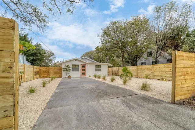 a view of a house with a yard covered in snow
