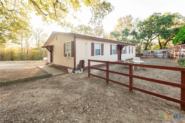 a view of a house with a yard and sitting area