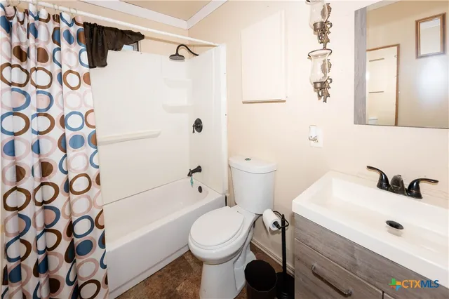 a bedroom with a bed and a flat tv screen on a dresser