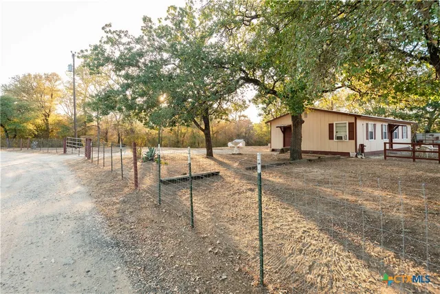 a backyard of a house with barbeque oven