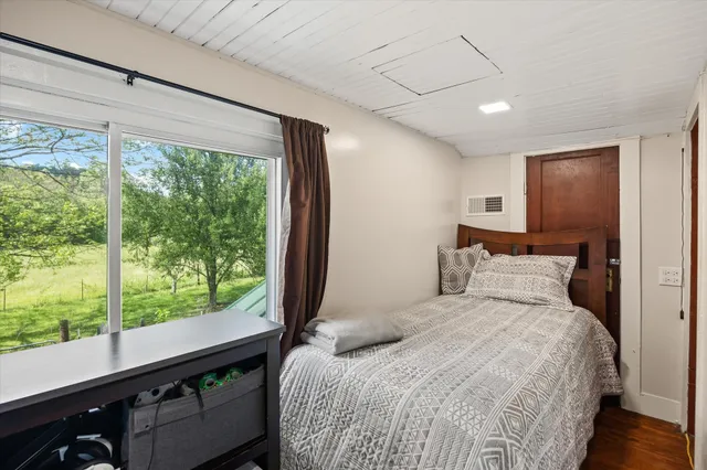 a bedroom with a large bed and a large window