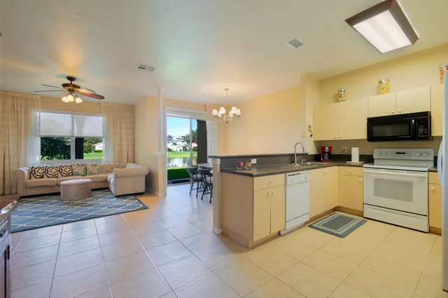 a kitchen with a sink and white cabinets