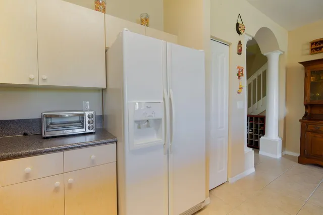 a kitchen with stainless steel appliances granite countertop a refrigerator and a stove
