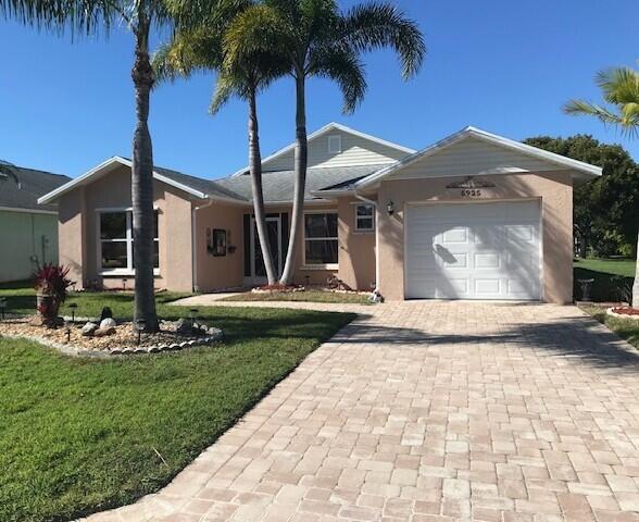 5925 Foxtail Way Fort Pierce, FL 34982 - Photo 1 of 29 a front view of a house with a garden and yard