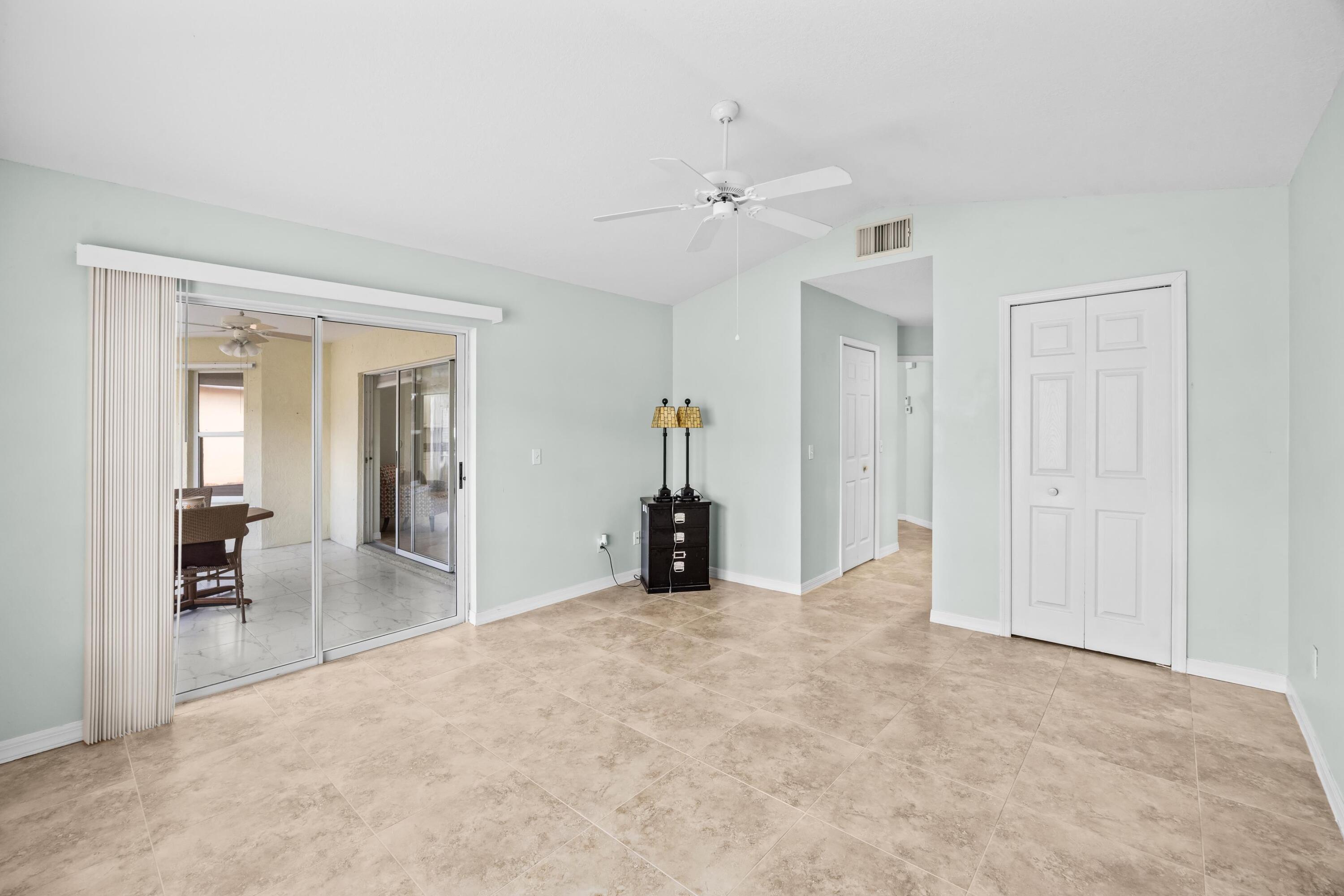 5925 Foxtail Way Fort Pierce, FL 34982 - Photo 13 of 29 a view of a livingroom with a chandelier fan and closet area