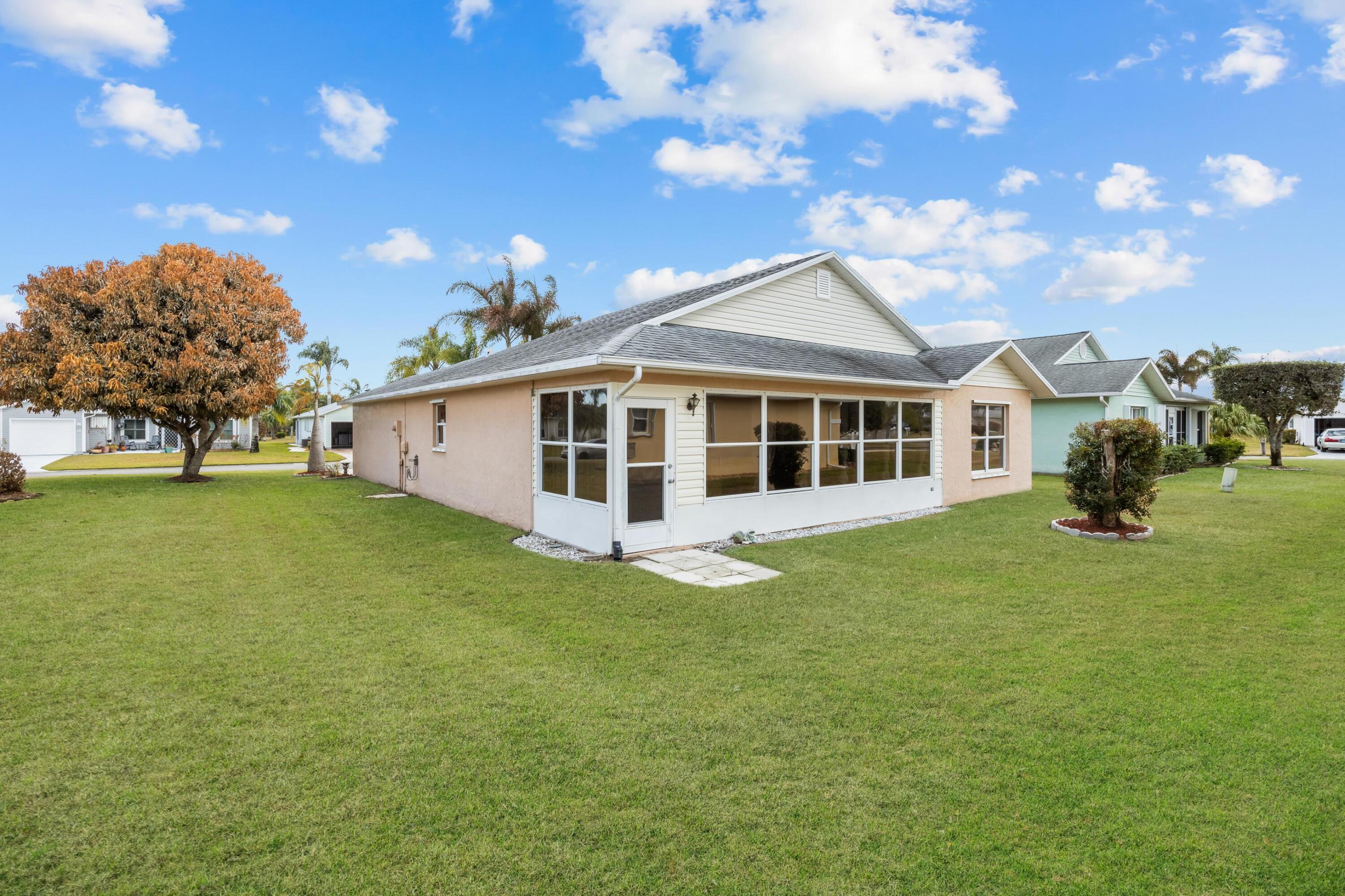 5925 Foxtail Way Fort Pierce, FL 34982 - Photo 24 of 29 a front view of a house with garden