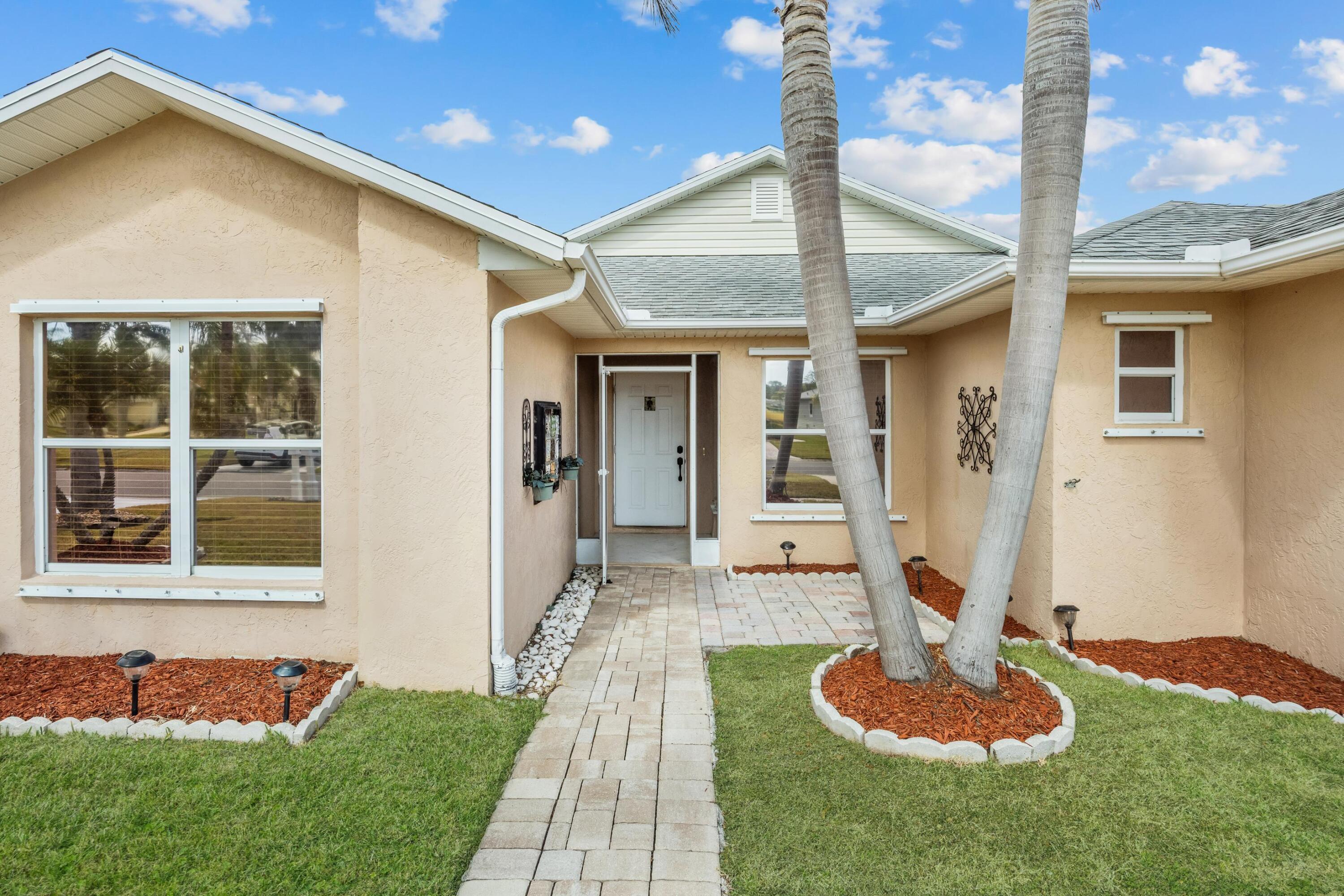 5925 Foxtail Way Fort Pierce, FL 34982 - Photo 25 of 29 a front view of a house with a yard