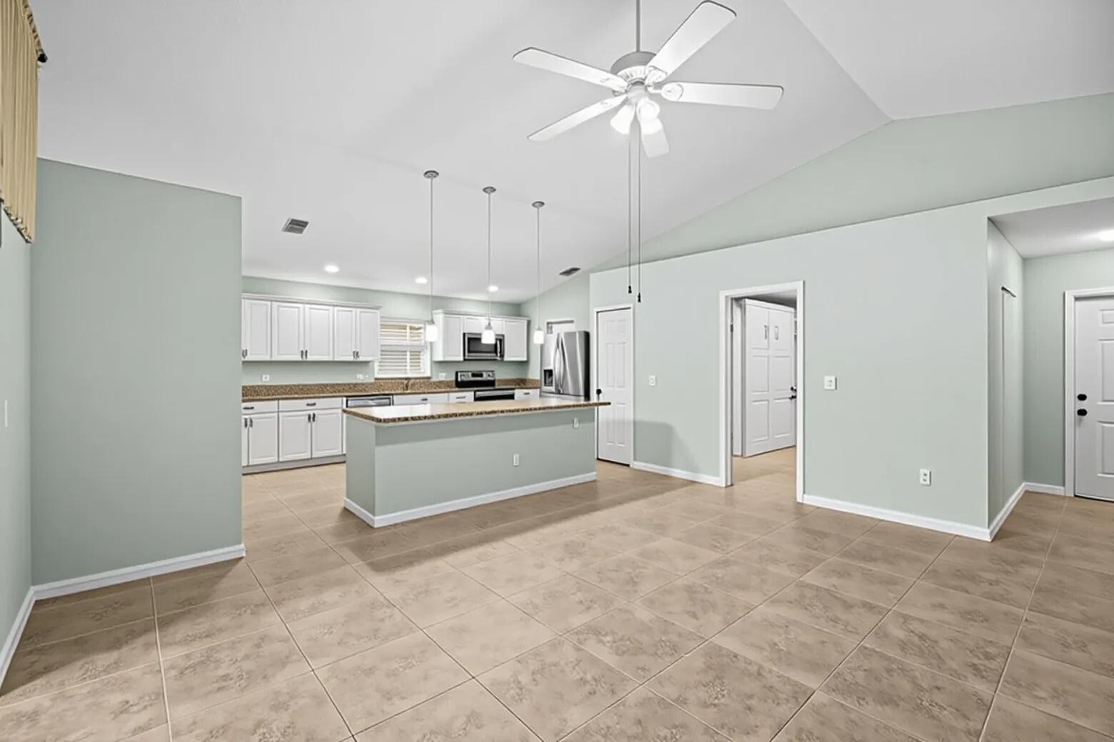 5925 Foxtail Way Fort Pierce, FL 34982 - Photo 3 of 29 a view of kitchen with stainless steel appliances cabinets a sink and a stove