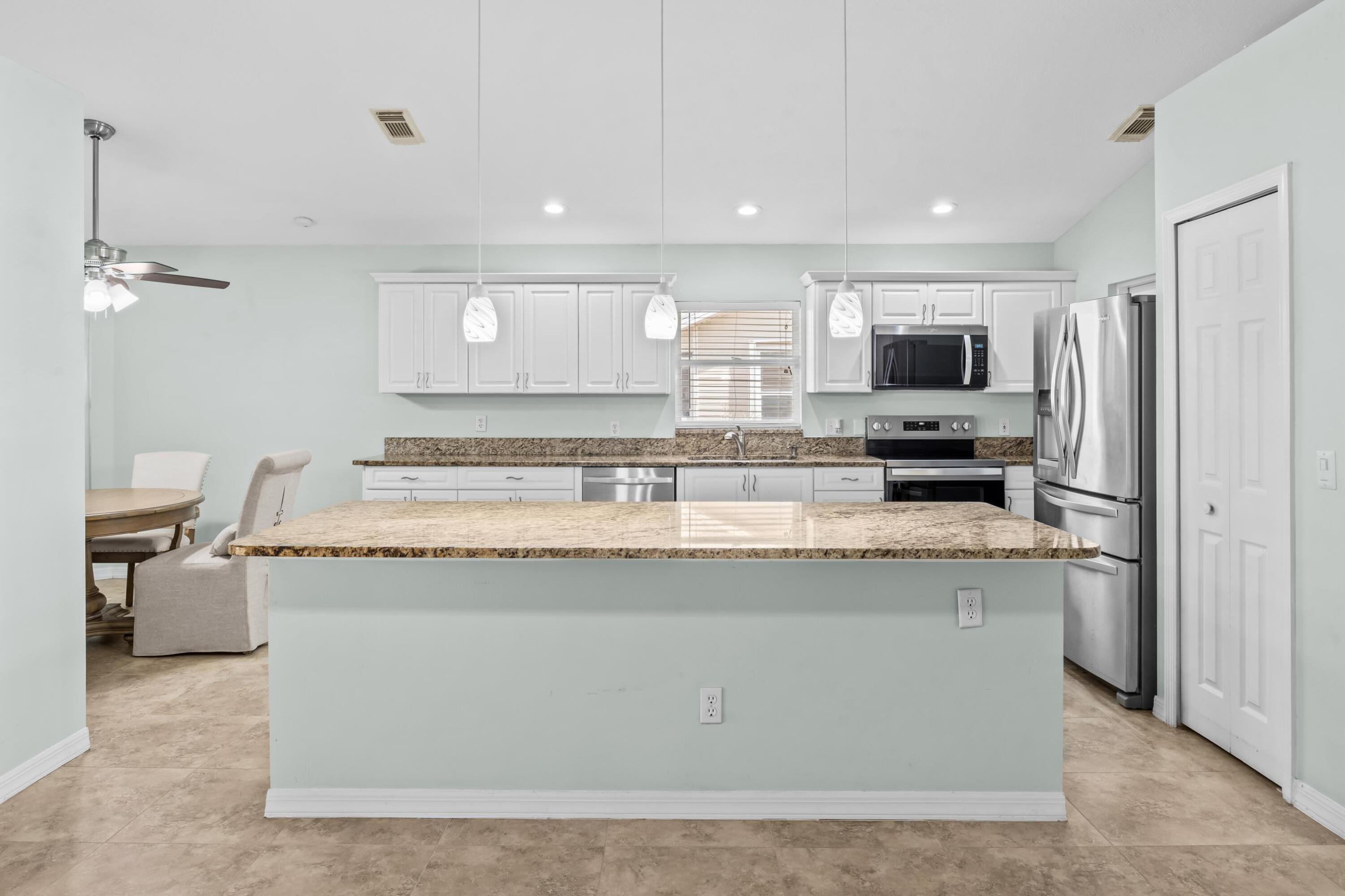 5925 Foxtail Way Fort Pierce, FL 34982 - Photo 7 of 29 a view of living room with stainless steel appliances granite countertop furniture and a view of living room