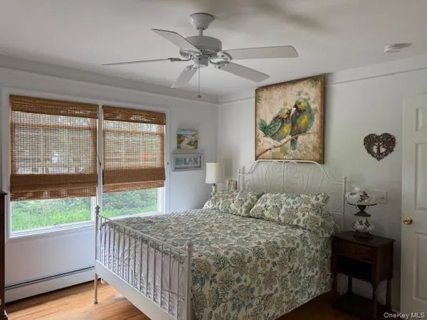 a bed sitting in a bedroom next to a window