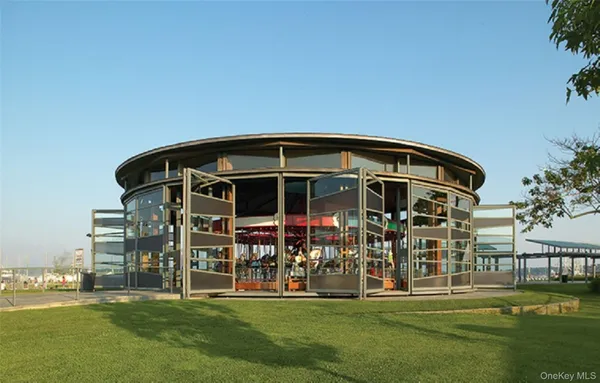 a view of a tables and chairs under an umbrella in patio