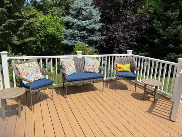 a living room with furniture wooden floor and a large window