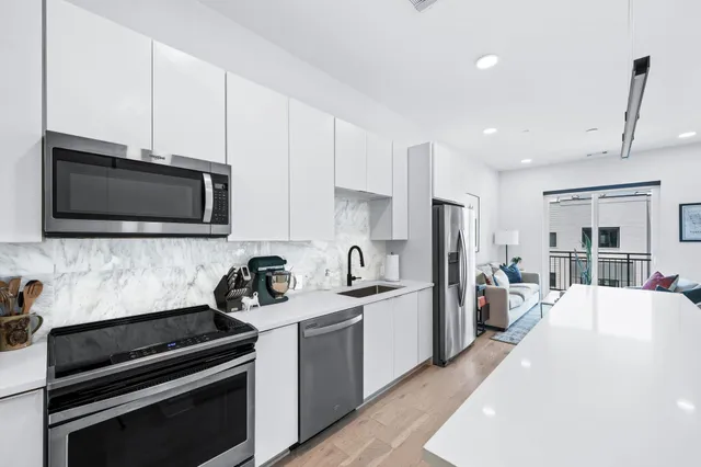 a dining room with furniture a rug and a chandelier