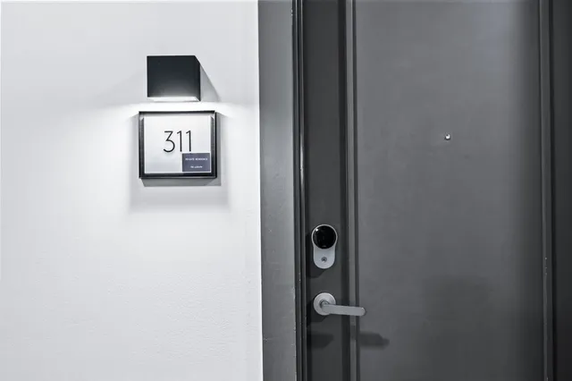 a view of a kitchen with white cabinets