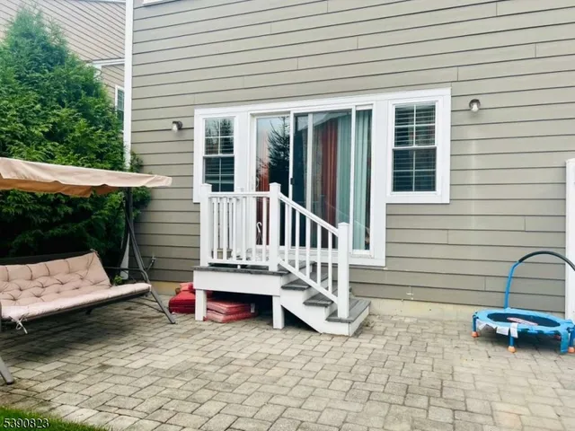 a view of a chair and table in the back yard of the house