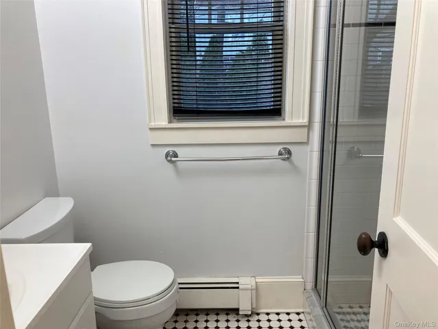 a bathroom with a toilet and a shower